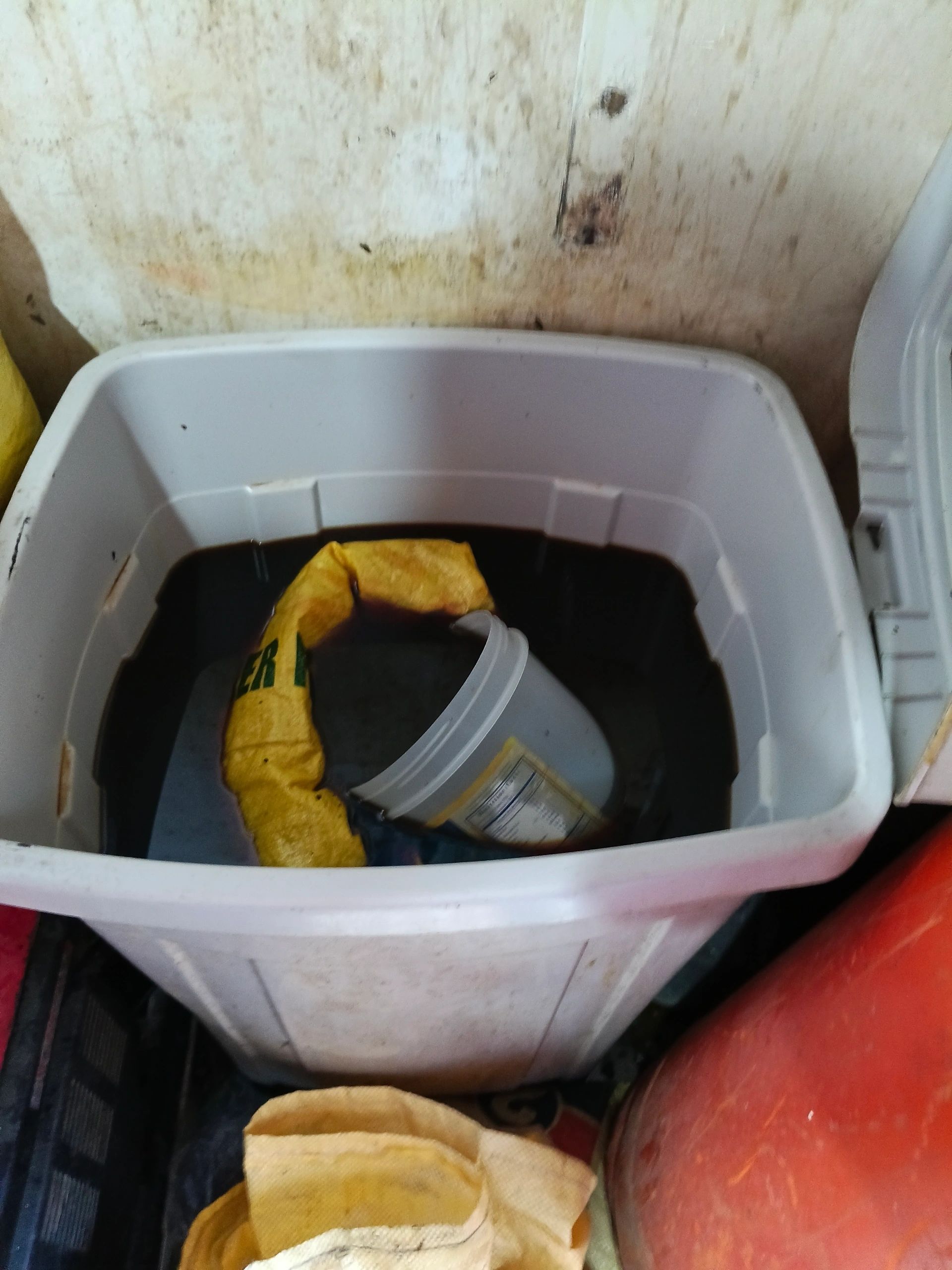 Open bin of used cooking oil stored unsafely