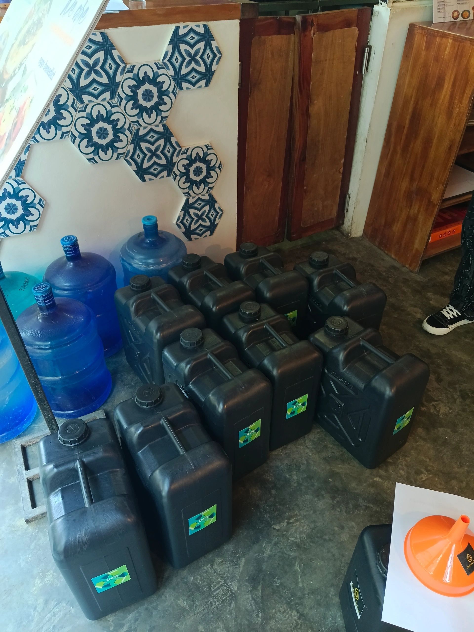 A row of Clean Oils containers at a partner kitchen